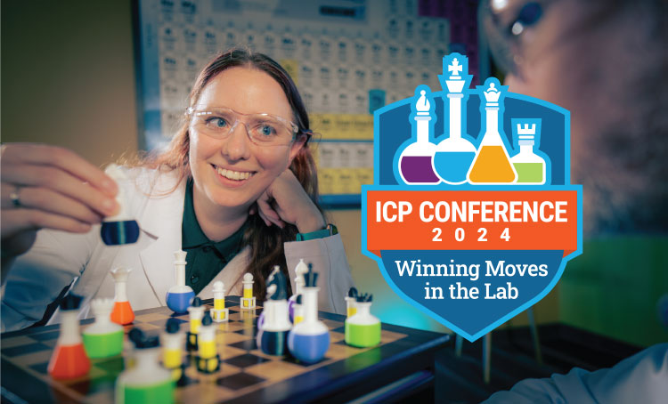 Woman in a lab coat holding a chess piece shaped like a lab beaker.